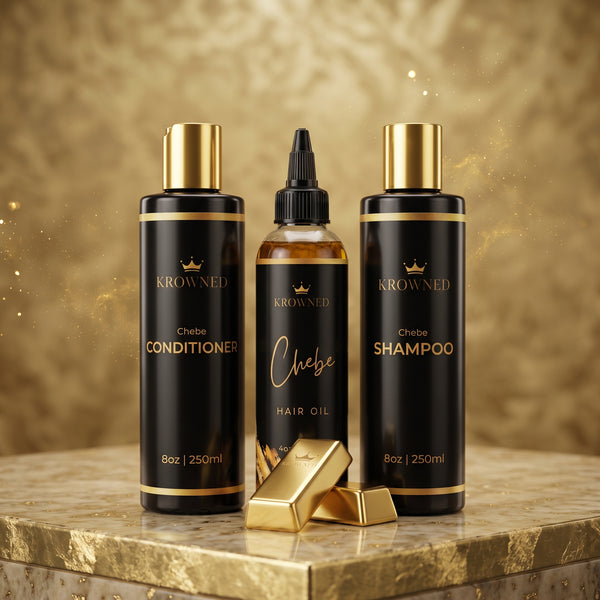 Three hair care products from KROWNED are displayed on a gold marble surface against a sparkling gold background: Chebe Conditioner, Chebe Shampoo, and Chebe Hair Oil, with two gold bars in front.