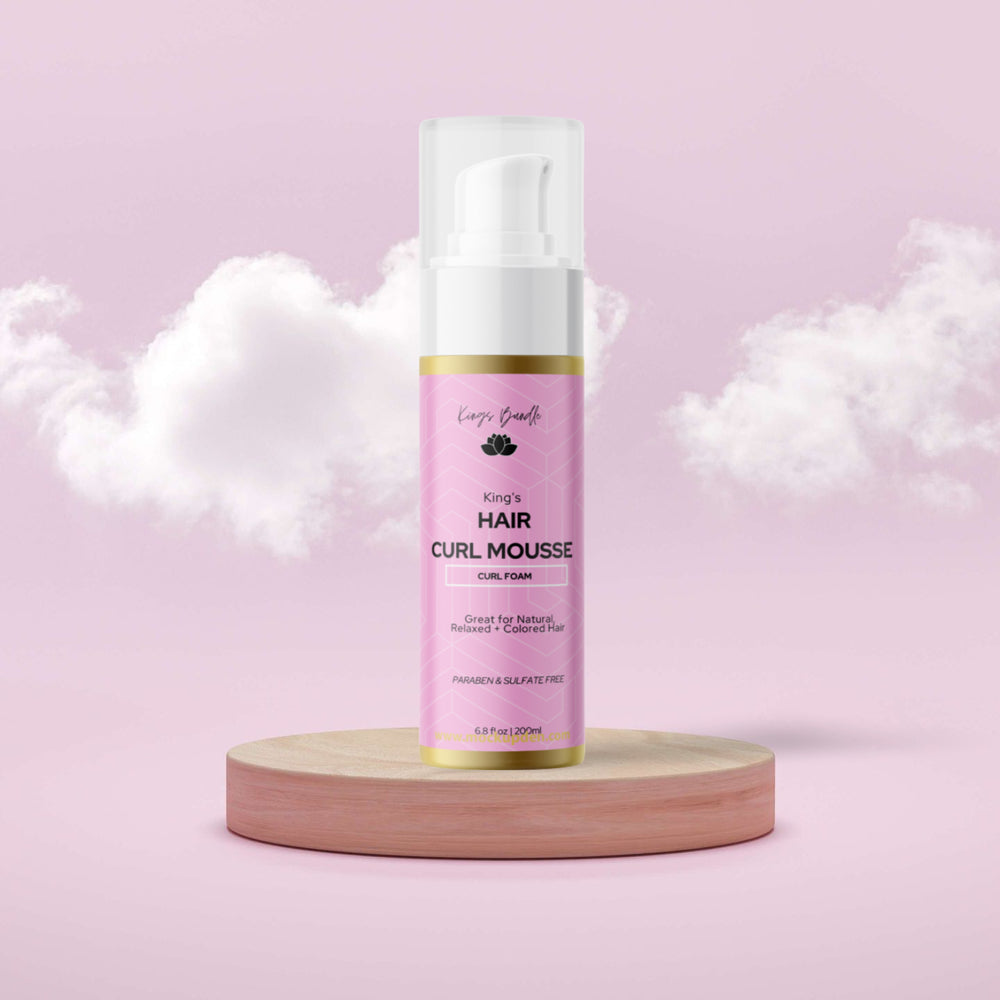Pink bottle of King's Hair Curl Mousse on a pink background with clouds