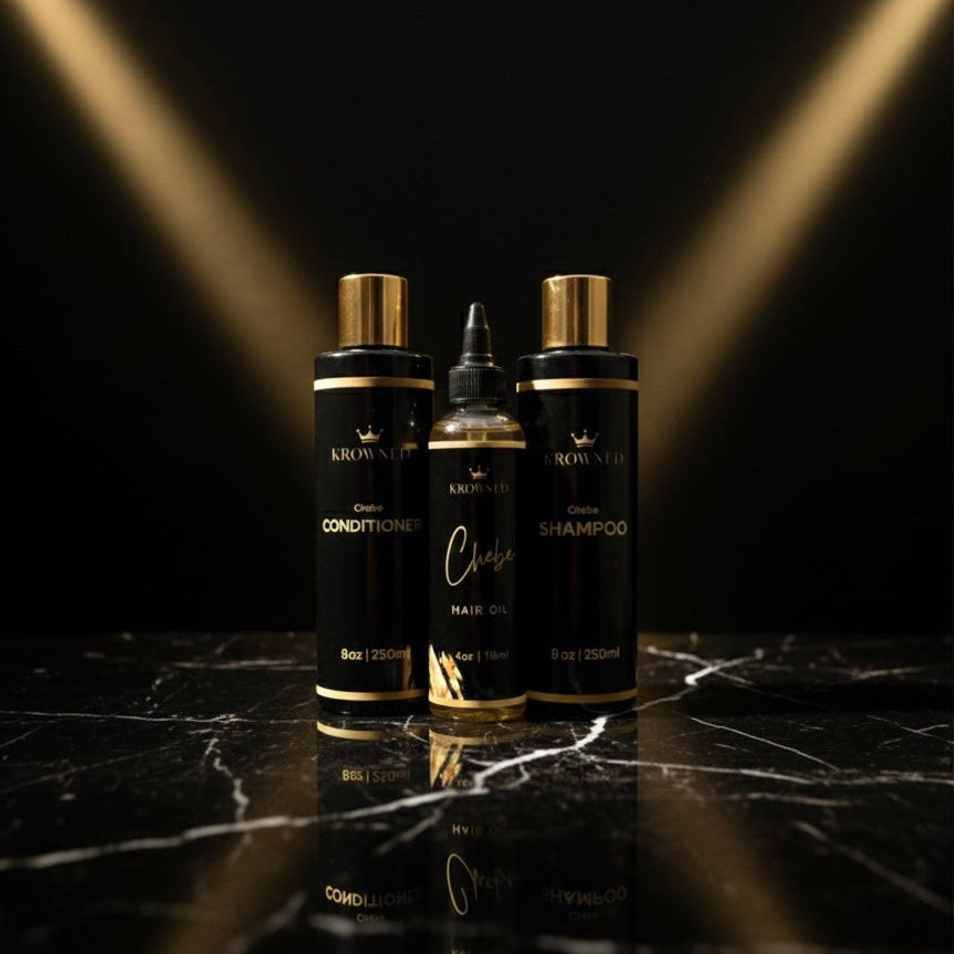 Three Krown & Me hair care products on a black marble surface with gold accents.