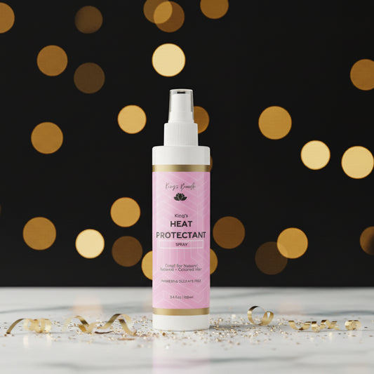 Heat protectant spray bottle with pink label on a white background