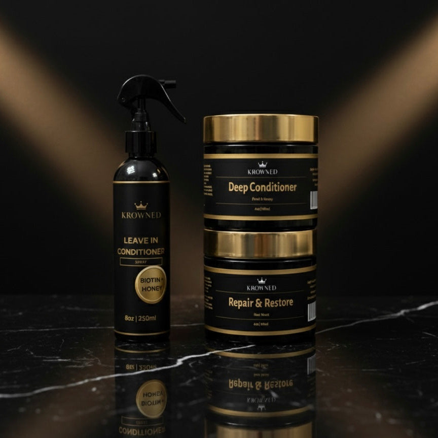 KROWNED hair care products including a spray bottle and jars on a reflective surface with a dark background.
