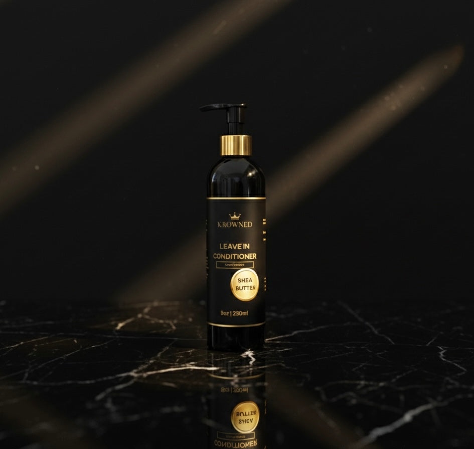 Black and gold bottle of leave-in conditioner on a dark marble surface