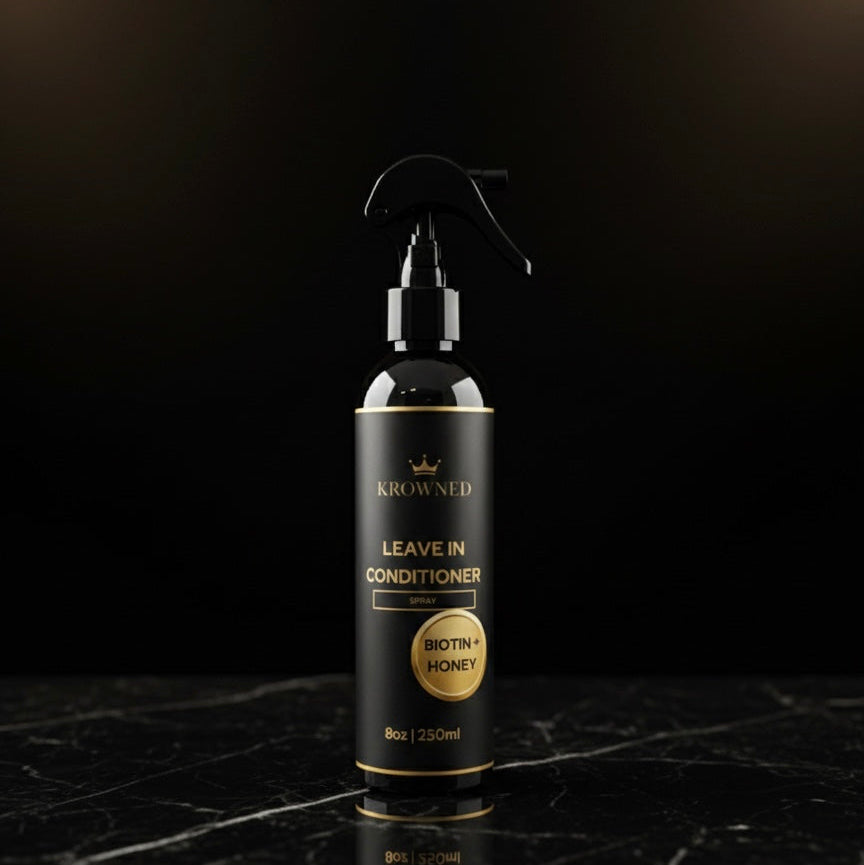 Leave-in conditioner bottle with 'Krowned' branding on a dark marble surface